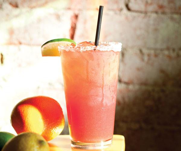 Pink pear margarita on the rocks with salt and lime.