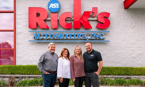 Rick Hughlett poses in front of Rick’s Automotive with his wife, Karen Hughlett, his daughter, Kala Comfort and his son-in-law, Travis Comfort.