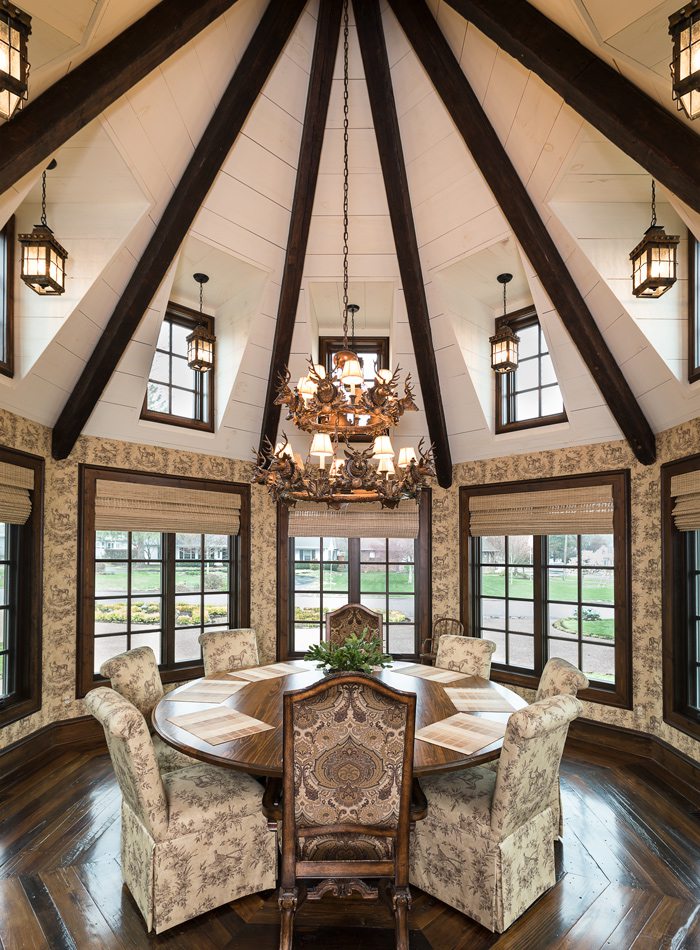 Tudor dining room with circular wood ceiling and wooden chandelier.