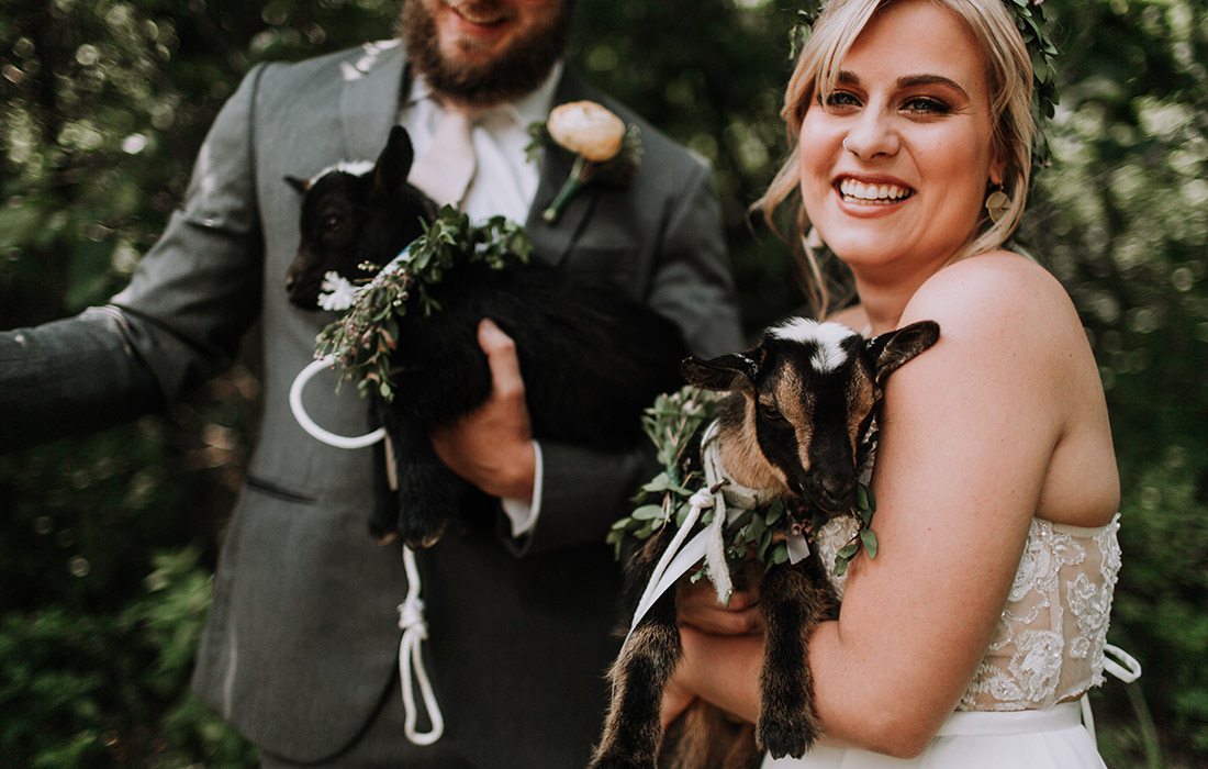 Ryan Kopas & Shai Voelker with baby goats on their wedding day