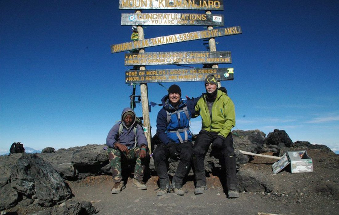 Dr. David Andereck at the peak of Mount Kilimanjaro