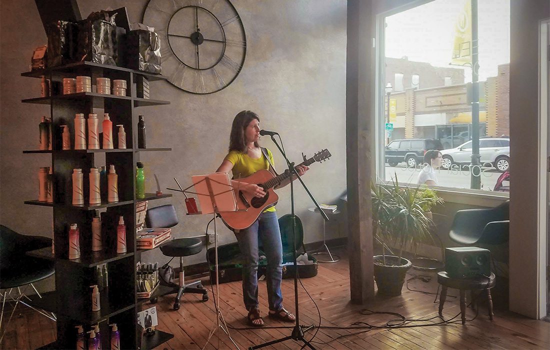 Sarah Smith plays guitar at Mane Salon and Social House