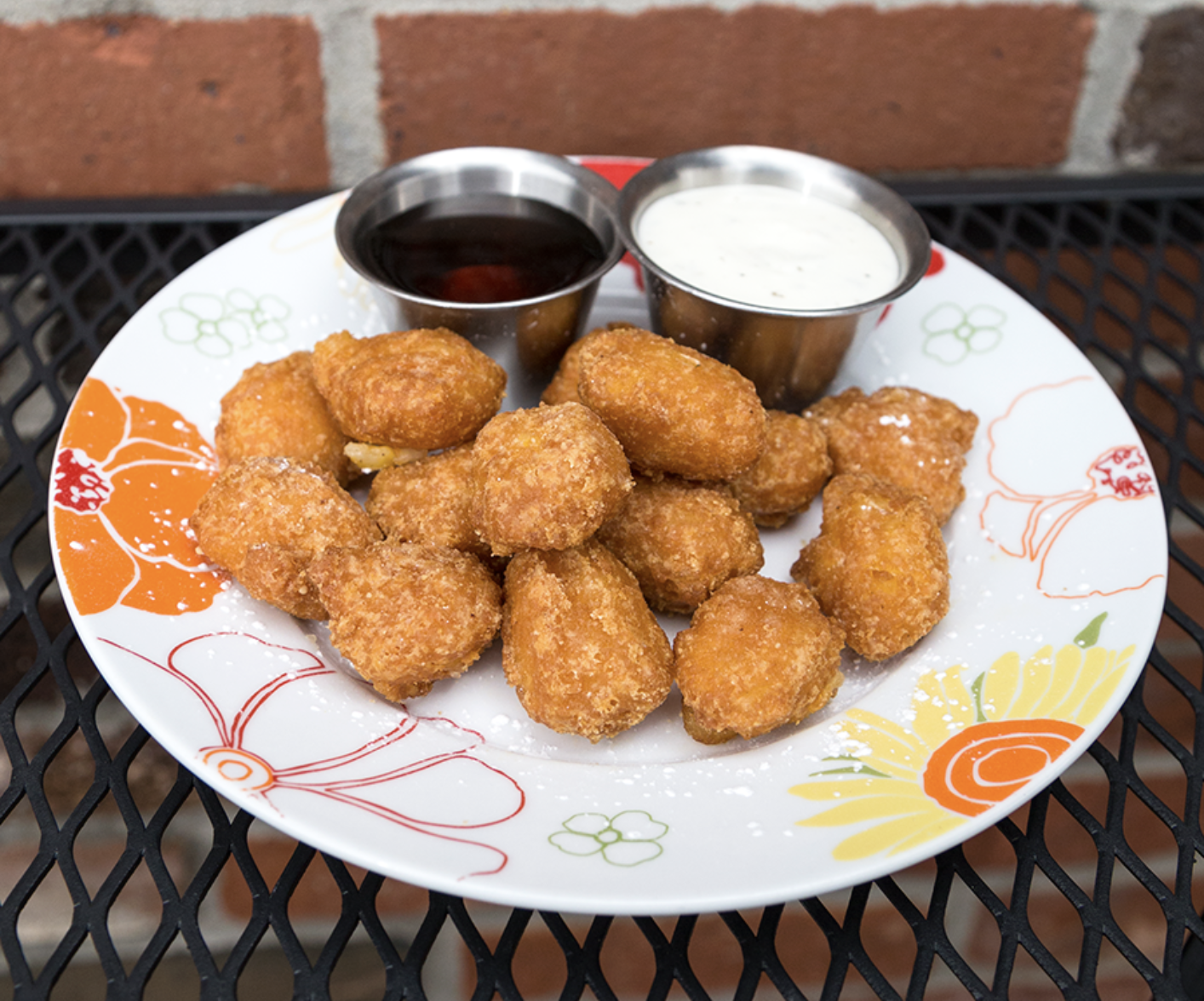 Fried corn nuggets with ranch and maple syrup.