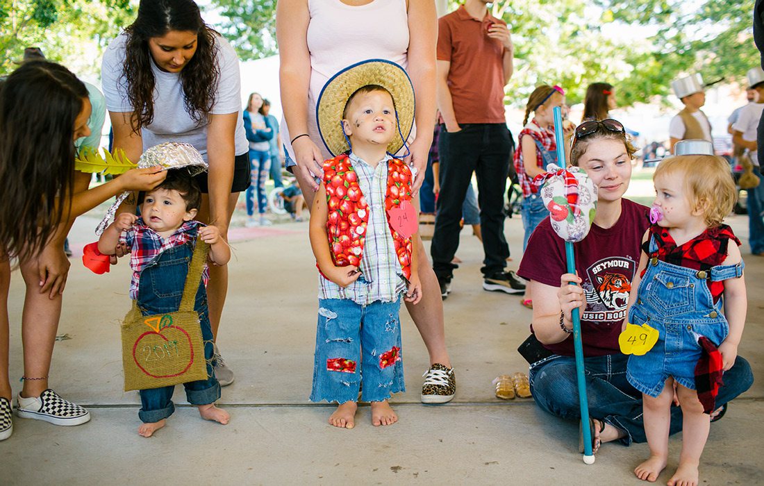 Kids dressed up in costumes at a fall festival