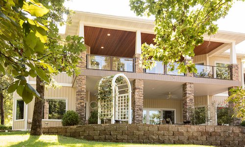 Backyard of home with stone details and patio space