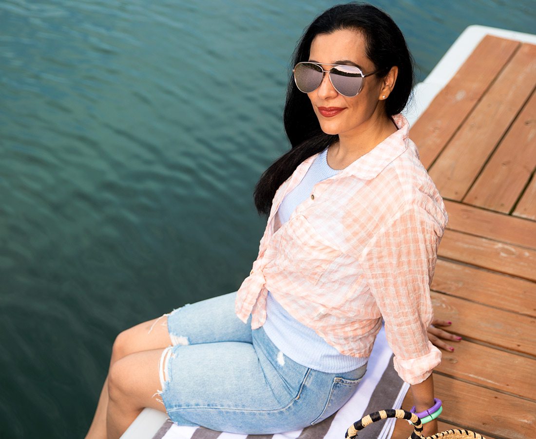 Summer style photoshoot model on the dock