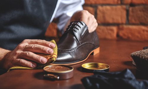 man shining a shoe