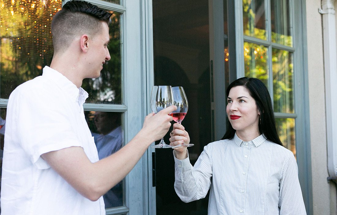 Friends clinking glasses of wine at Elle Feldman's summer garden party