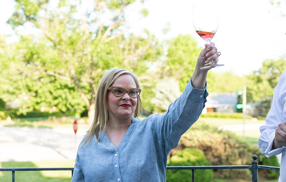 Elle Feldman toasting friends at her French summer garden party