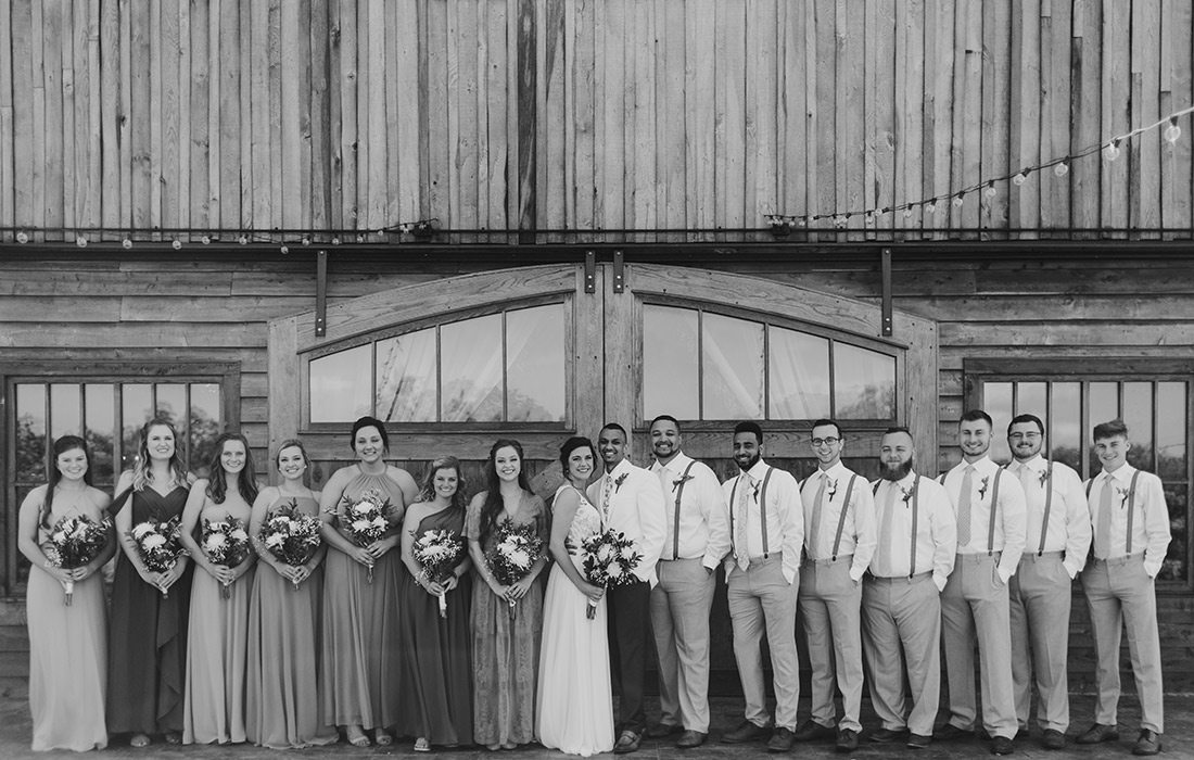 Taylor Abraham & Corey Holmes with their wedding parry on their wedding day