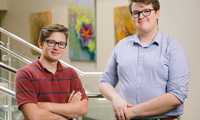 Brenden Reeves and Taylor Flores standing at staircase