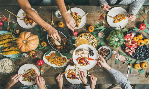 Overhead shot of family and friends enjoying a Thanksgiving meal together