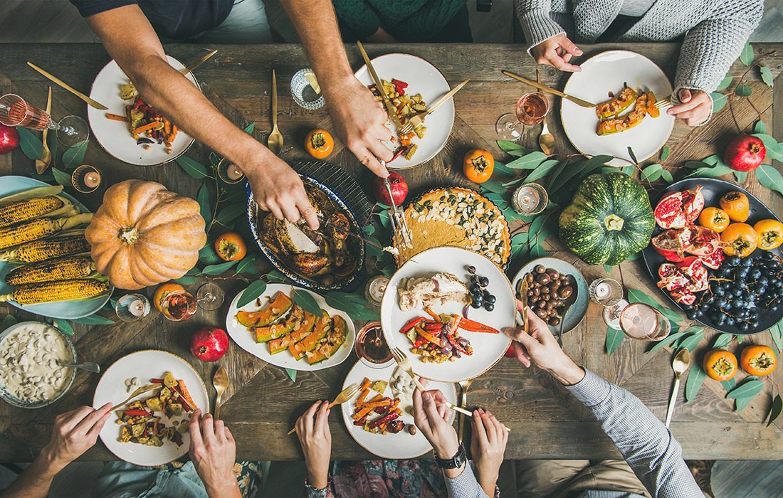 Overhead shot of family and friends enjoying a Thanksgiving meal together