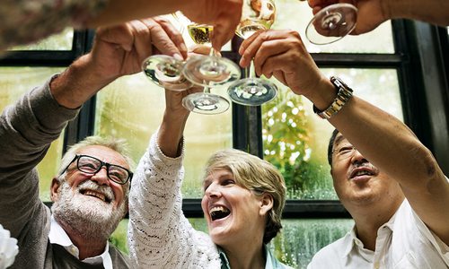 Senior friends in a retirement community enjoying a glass of wine