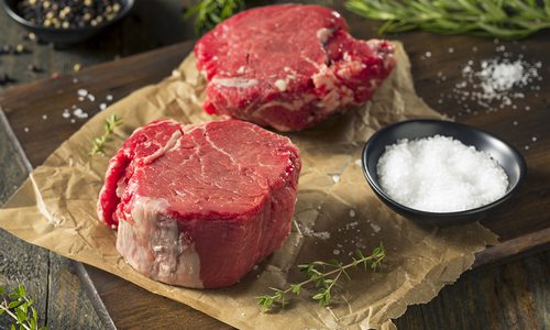 Raw filet mignon with herbs and salt