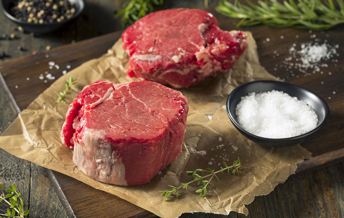 Raw filet mignon with herbs and salt