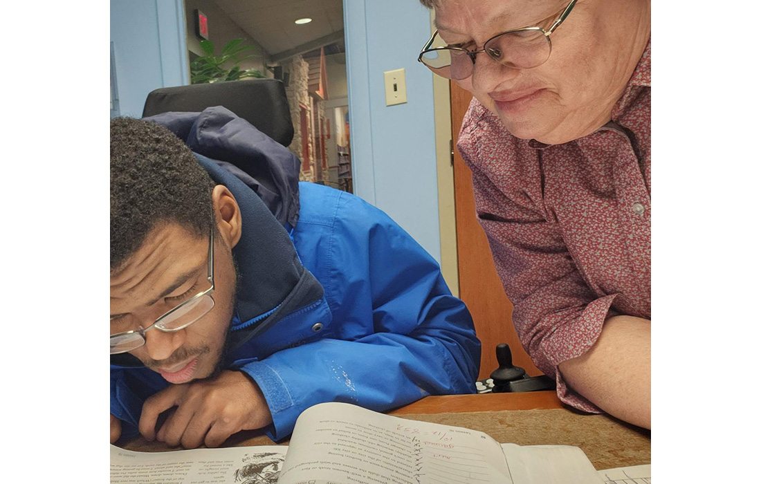 Betsy Dougherty helping kids with homework.