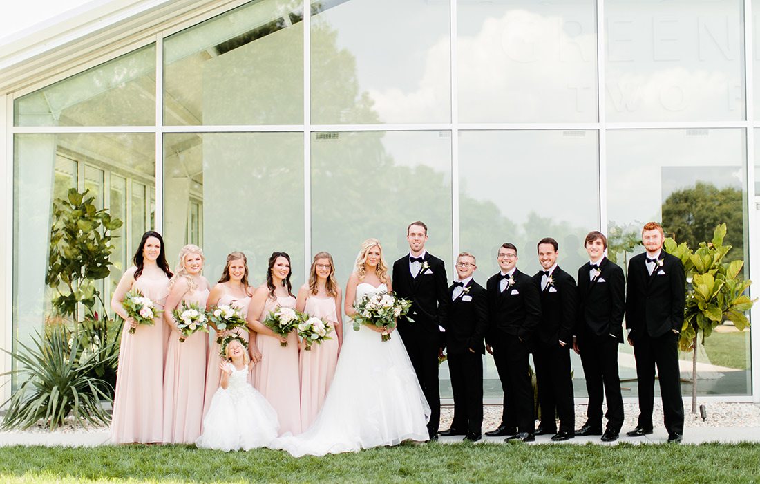 Valerie Moore & Jacob Johnson with their wedding party on their wedding day