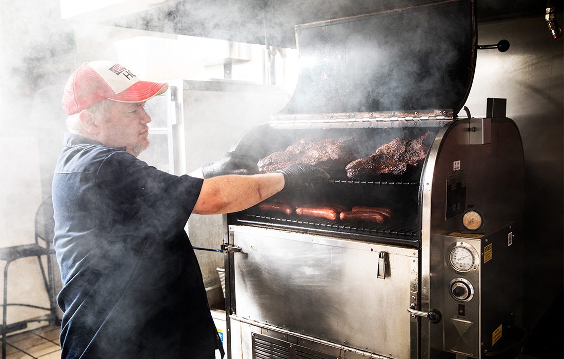 Wes Jounson pulls meat from smoker