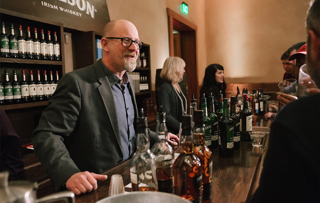 People drinking whiskey together
