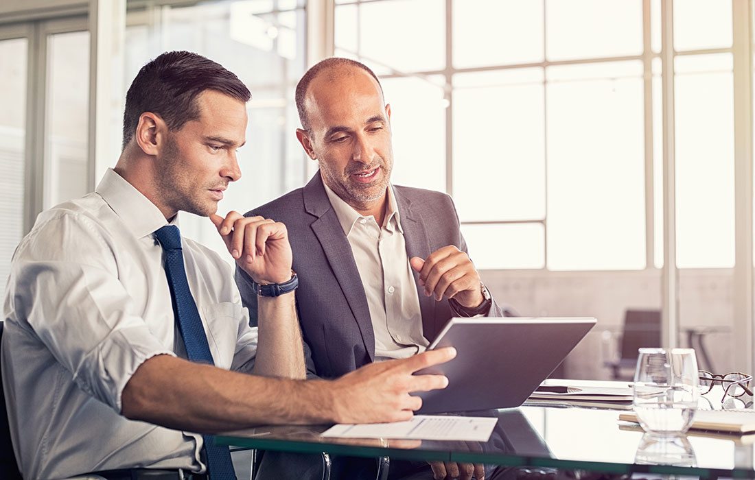 two men working together on a project at work