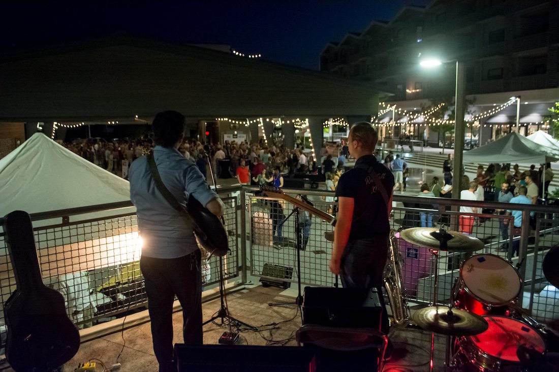 two musicians play at a wine and whiskey festival