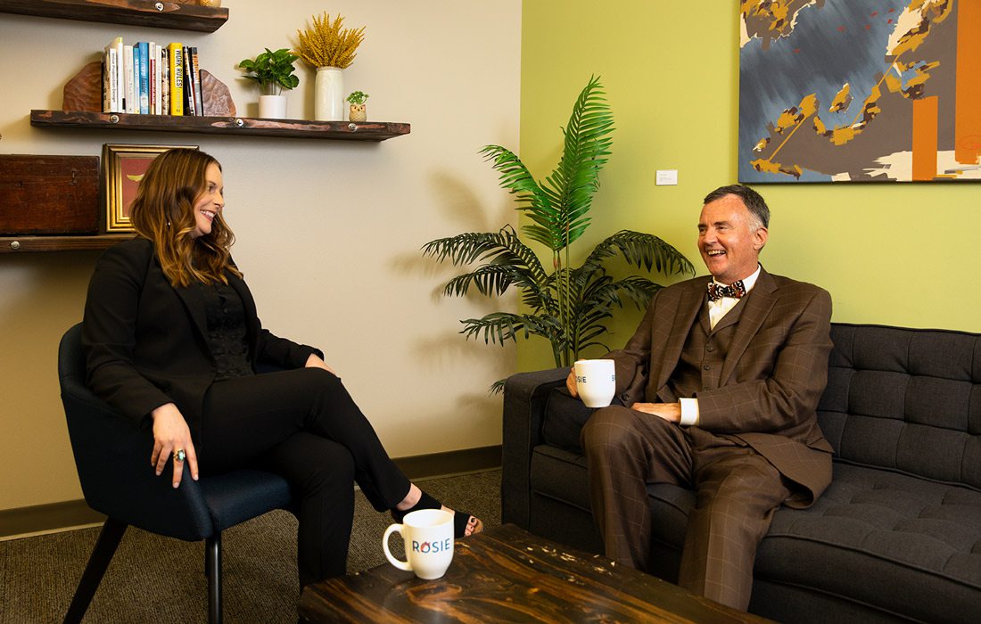 Rachel Anderson and Brian Fogle sitting across from one another