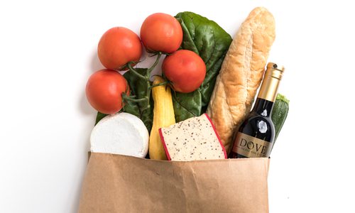 Paper grocery bag overflowing with produce