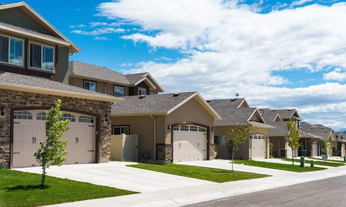 Suburban houses with nice green lawns.