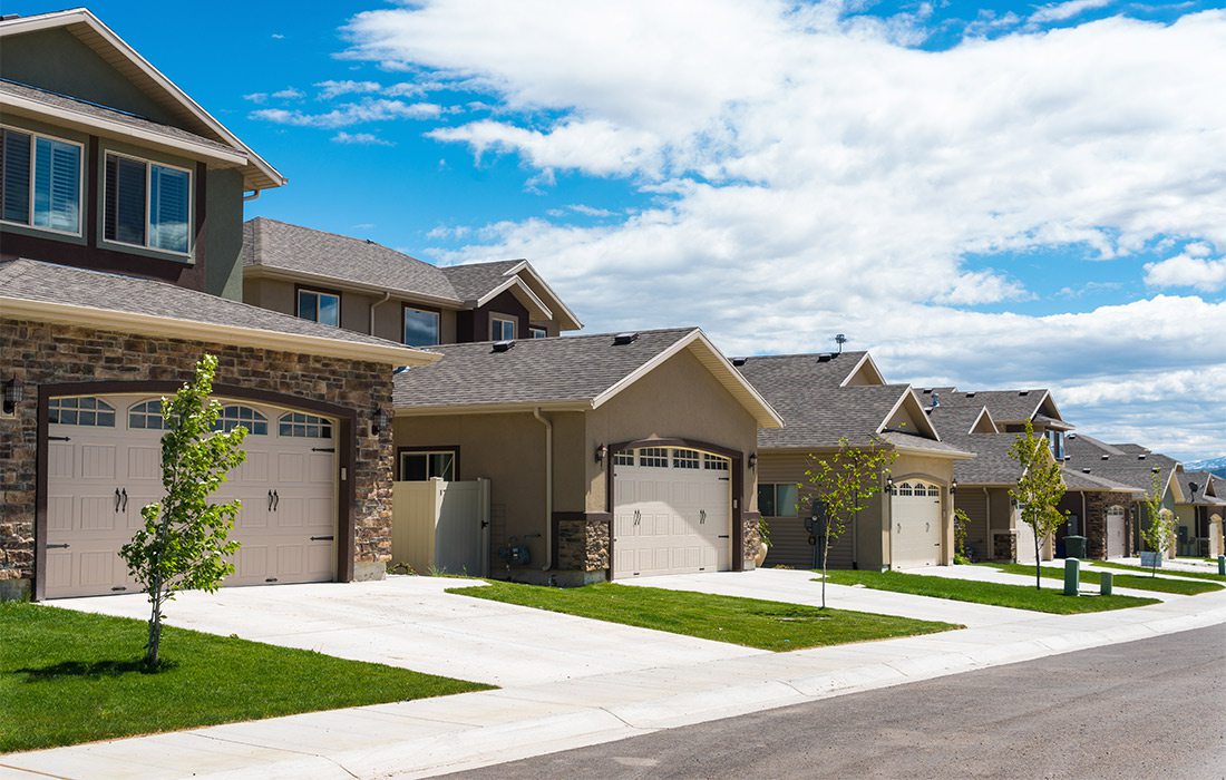 Suburban houses with nice green lawns.