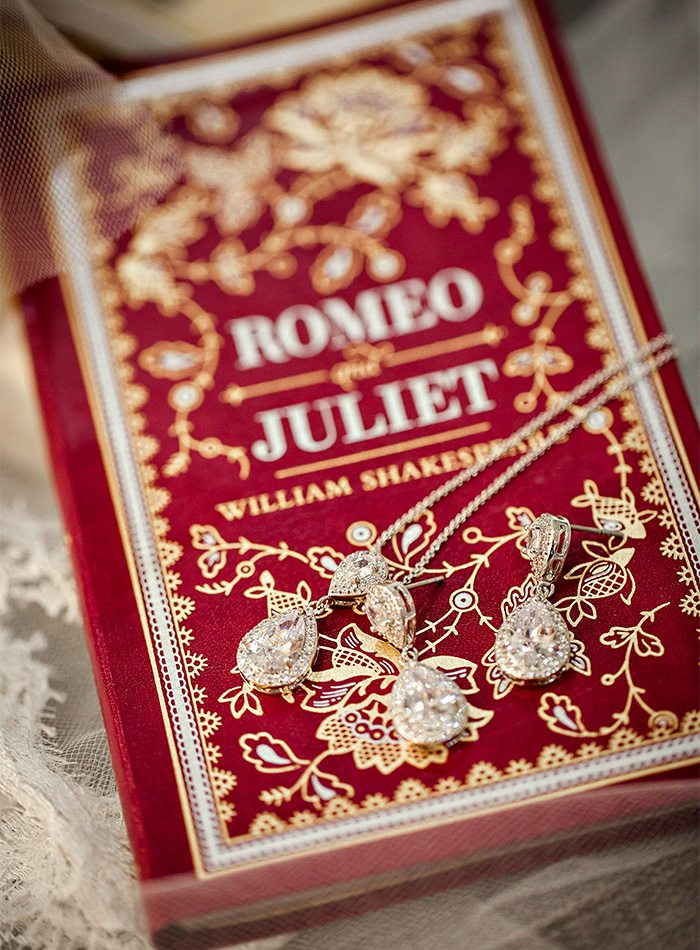 jewelry on top of a romeo and juliet book