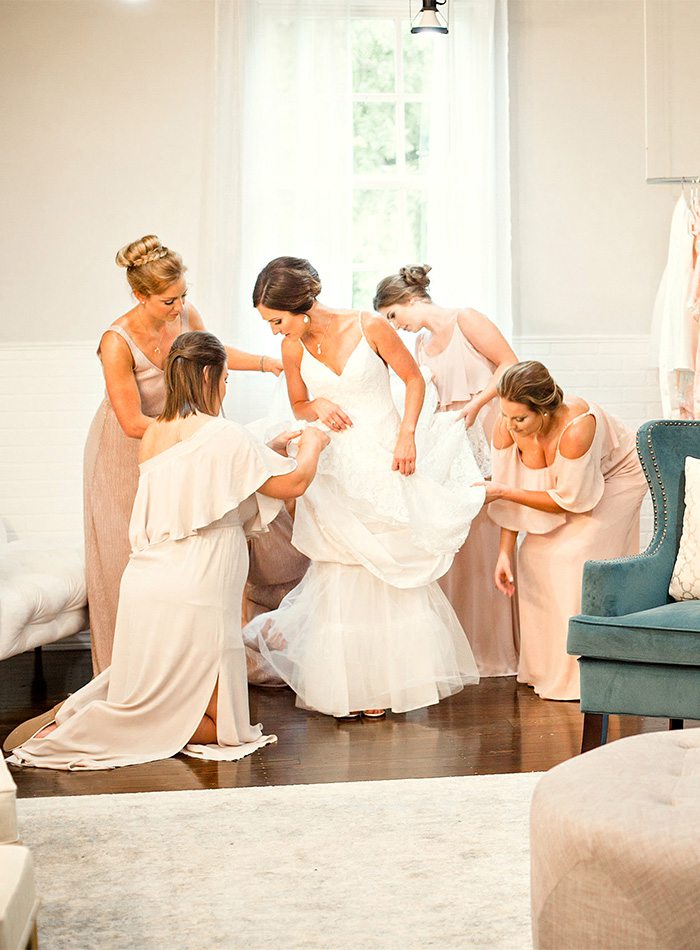 Bridesmaids helping the bride get ready for her wedding