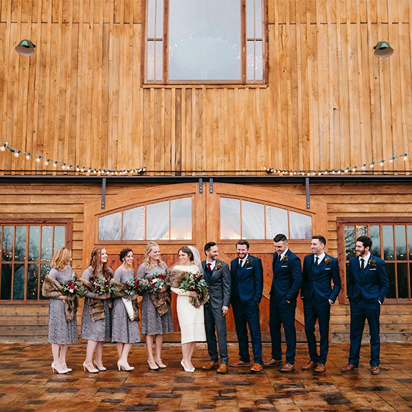 groomsmen and bridesmaids posing during a vintage wedding