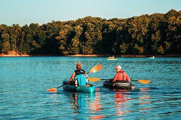 A man and a woman row with away towards land