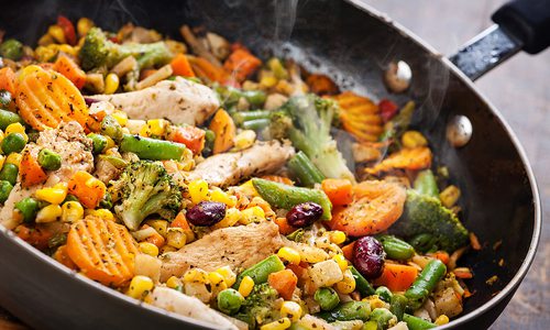 Stock image of stir fry cooking in a wok