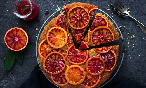 a vegan cake topped with orange slices