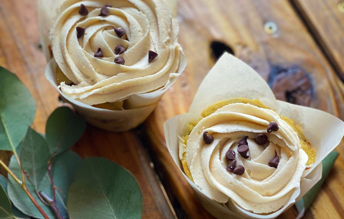 Two treats next to leaves on wooden background