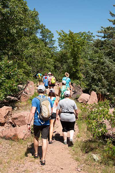 a group hikes up a large hill