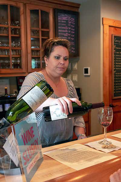 woman pours a glass of wine